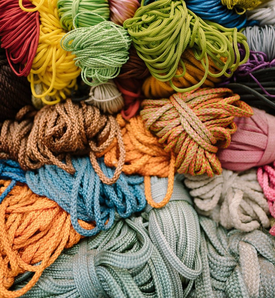 many varieties and colors of cord and utility line are all in a pile.
