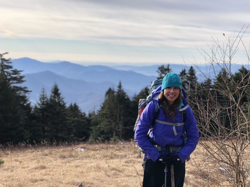 flower power 5 Flower Power posing for a picture while hiking the Appalachian Trail. She stands smiling with the mountains and trees behind her.