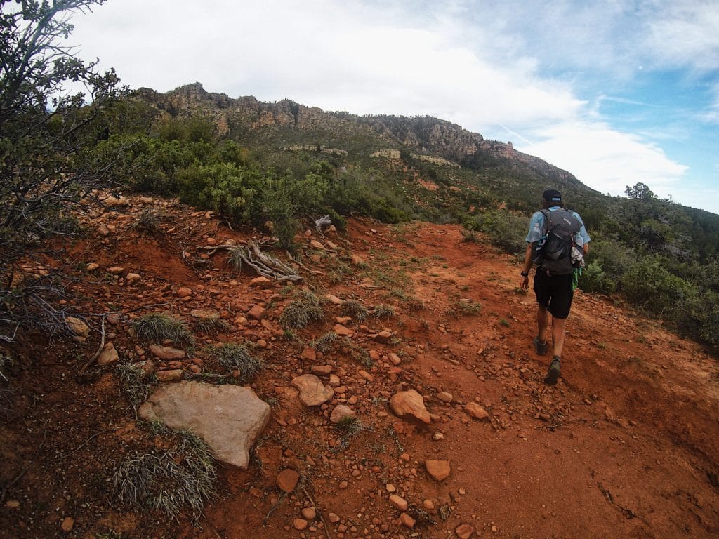 Jeff Garmire (Legend) walking up a red dirt hill.