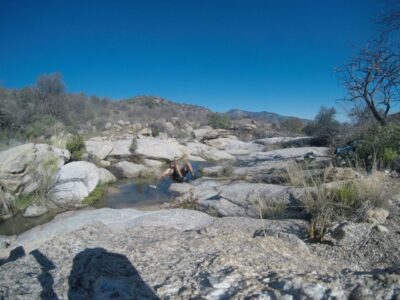 Jeff Garmire (Legend) cooling off in a river in the desert.