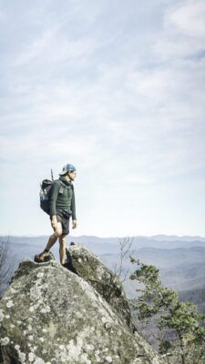 A hiker at a peak looking into the distance