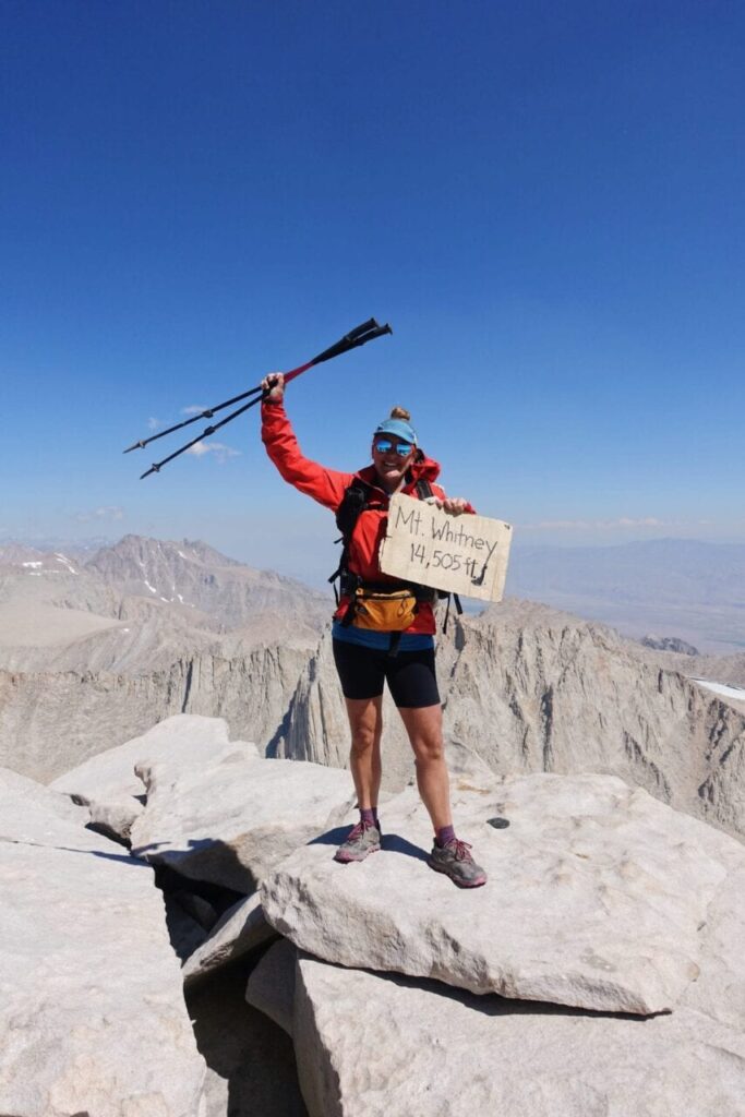 A popular pose for JMT thru-hikers. A hiker standing on top of Mount Whitney!