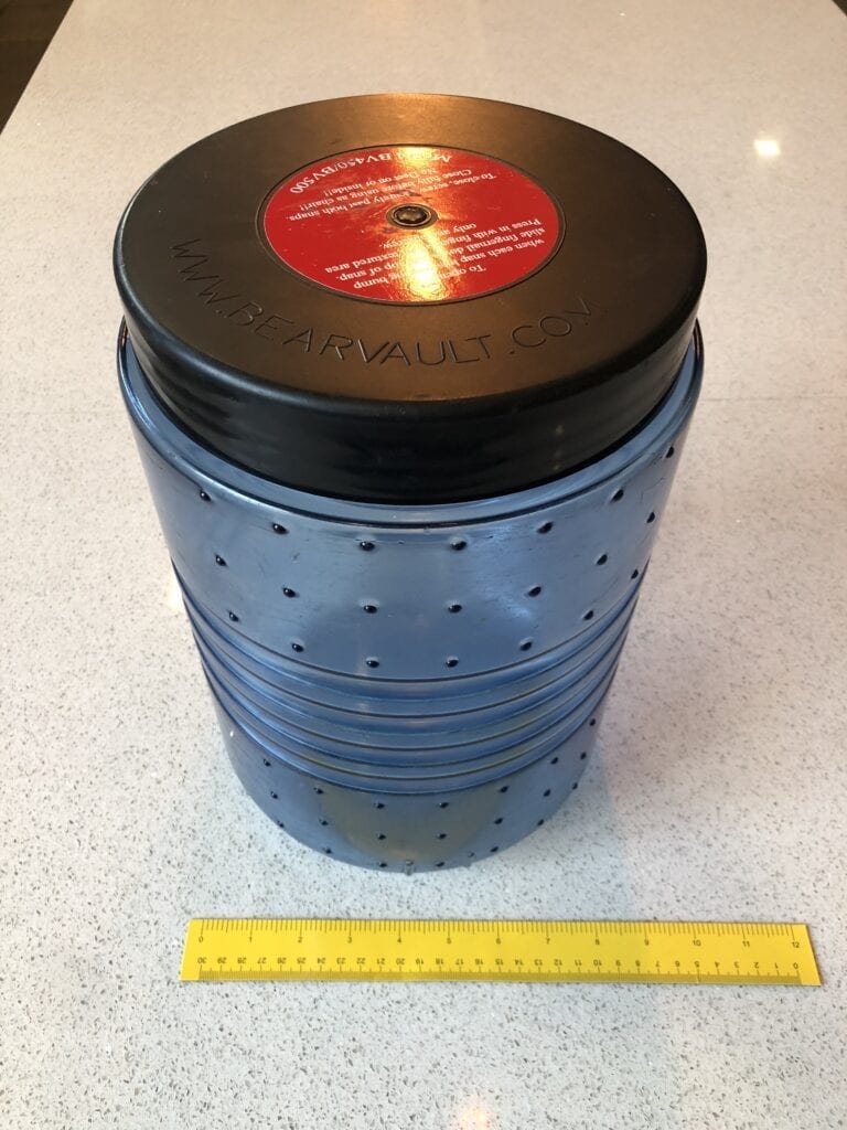A BV500 bear canister next to a ruler.