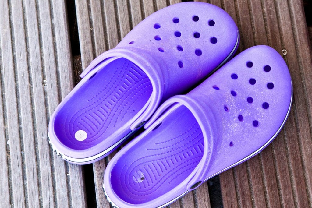 A pair of purple crocs shoes.