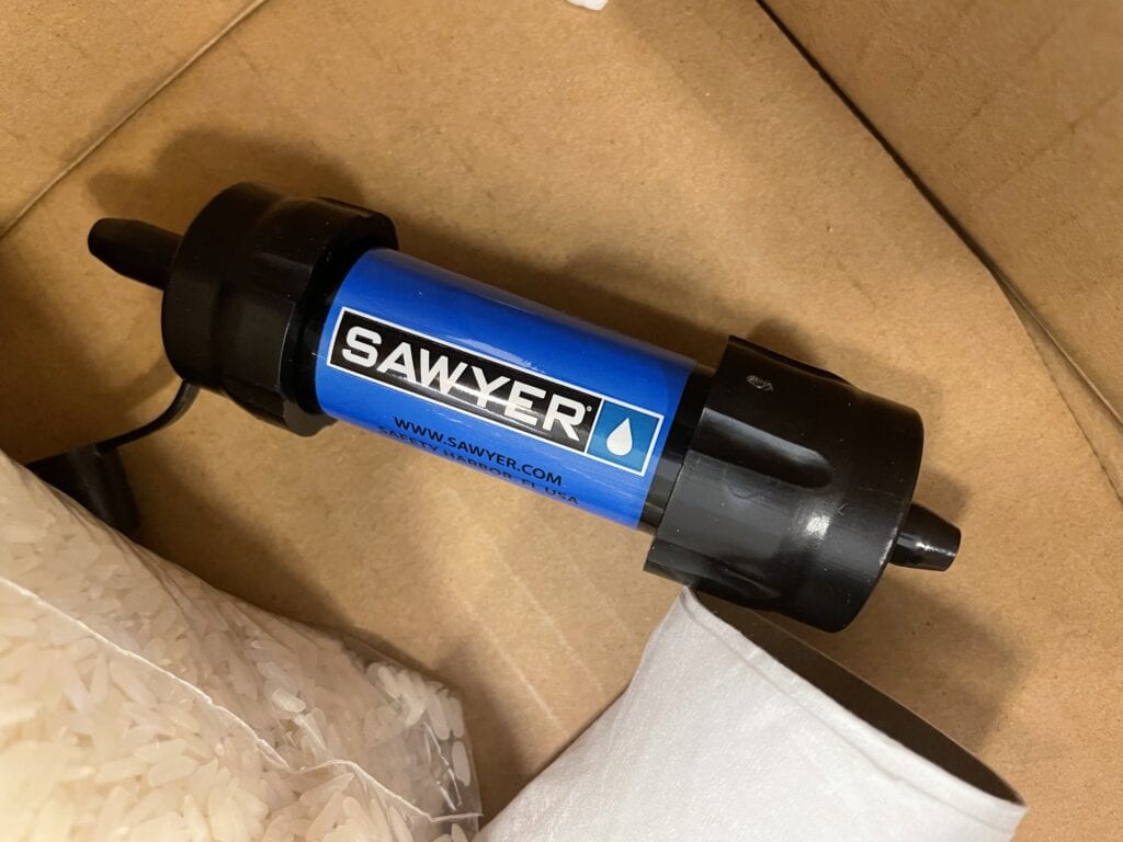 A Sawyer Mini water filter inside a hiker box