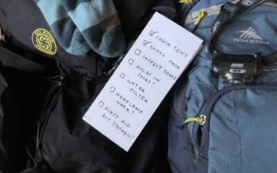 a checklist of thru-hiking maintenance on top of some backpacks