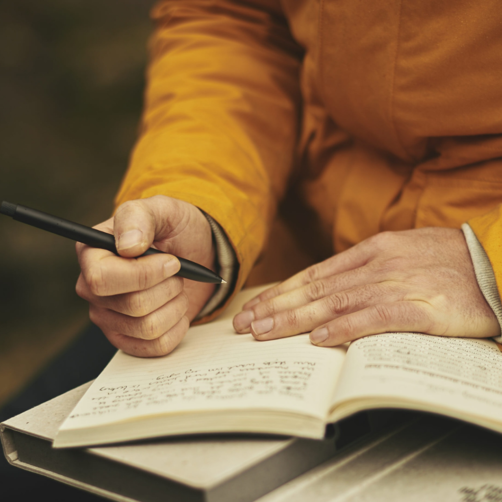 a man writing in a journal