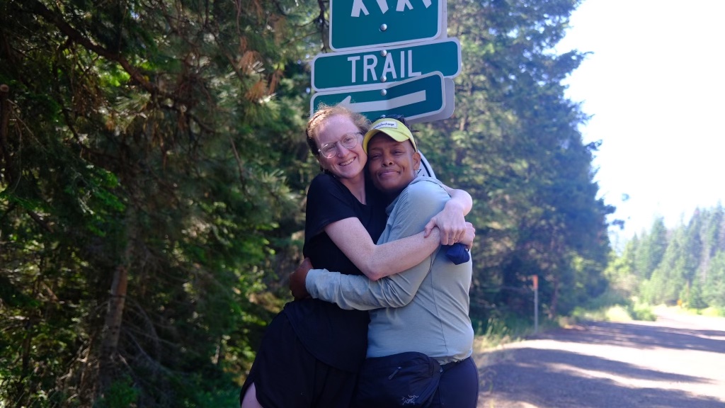 Two hikers hugging on the Pacific Crest Trail