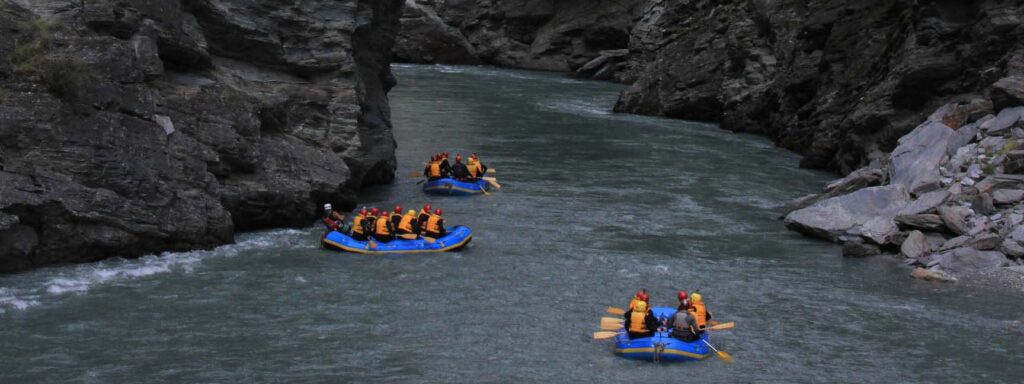 Three rafts floating down the Shotover River