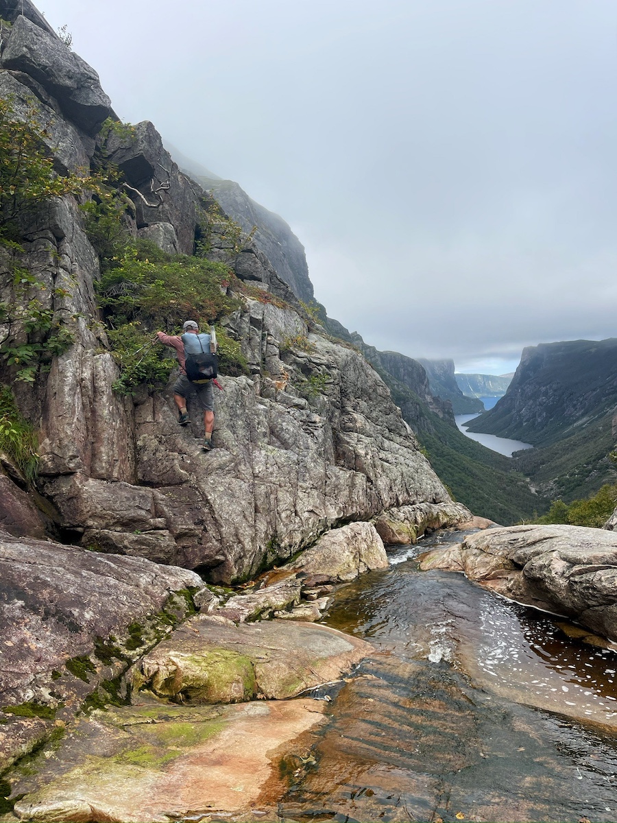 A hiker climbing a rocky mountainside on the ECT