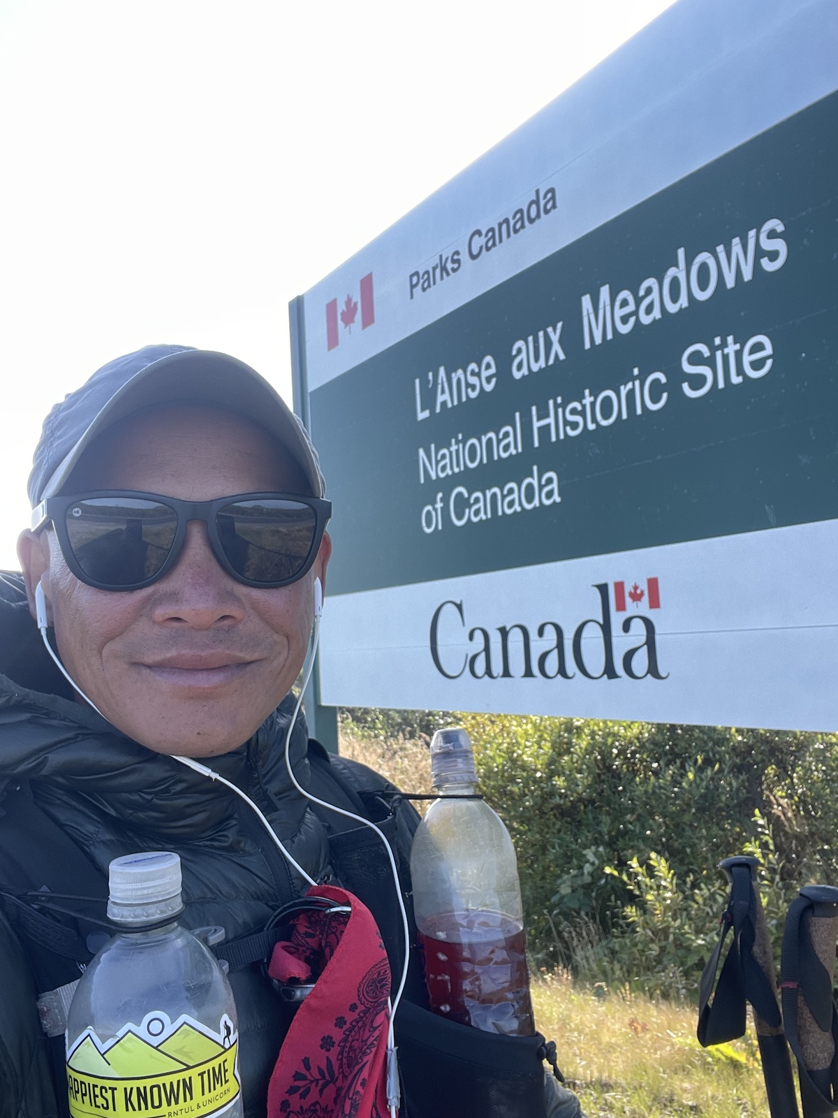 A hiker posing next to a Canada sign on the Eastern continental trail