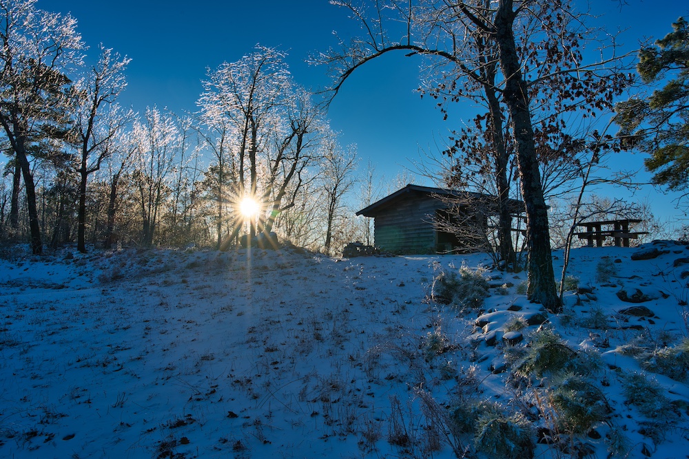 Ouachita Trail 4 - Danny Owens a snowy hill with a building on the Ouachita Trail