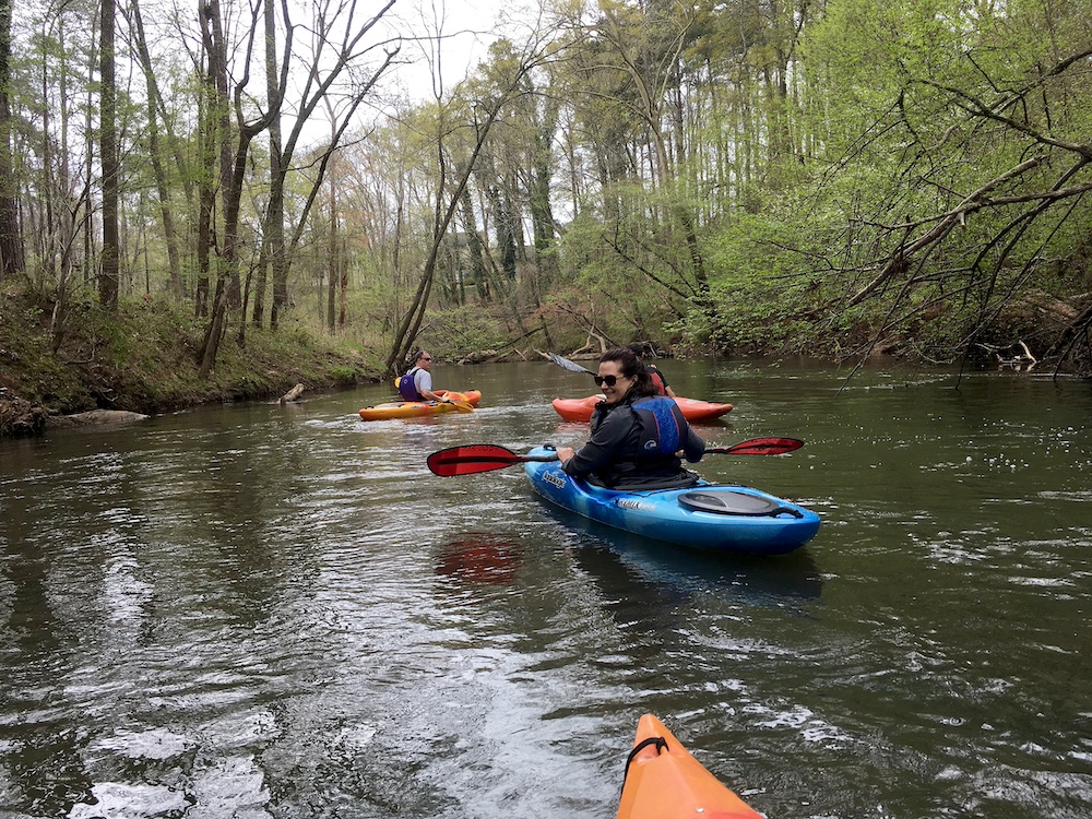 a few people in kayaks on a river in Georgia