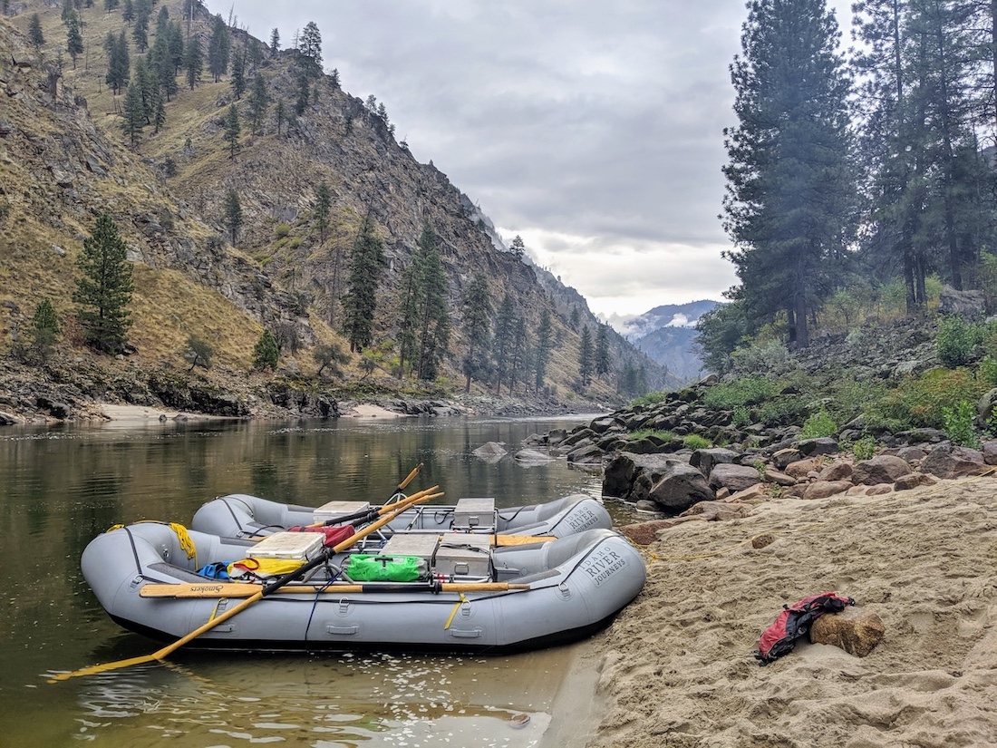 two rafts docked on a sandy beach on the main salmon river