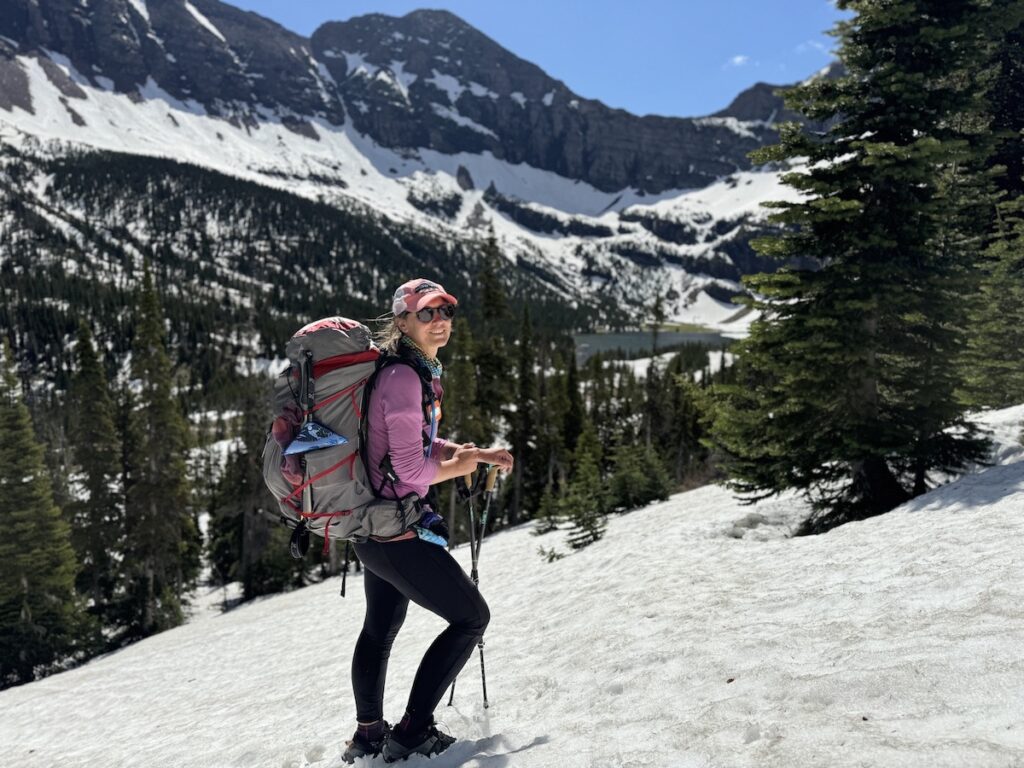 a hiker in the snow in glacier national park