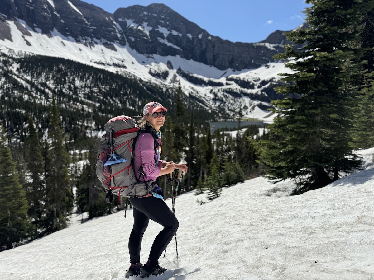 a hiker in the snow in glacier national park
