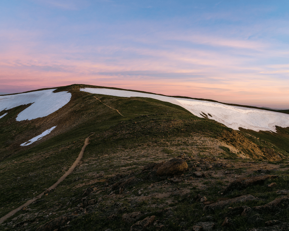 a view of a sunset on a mountain on the cdt