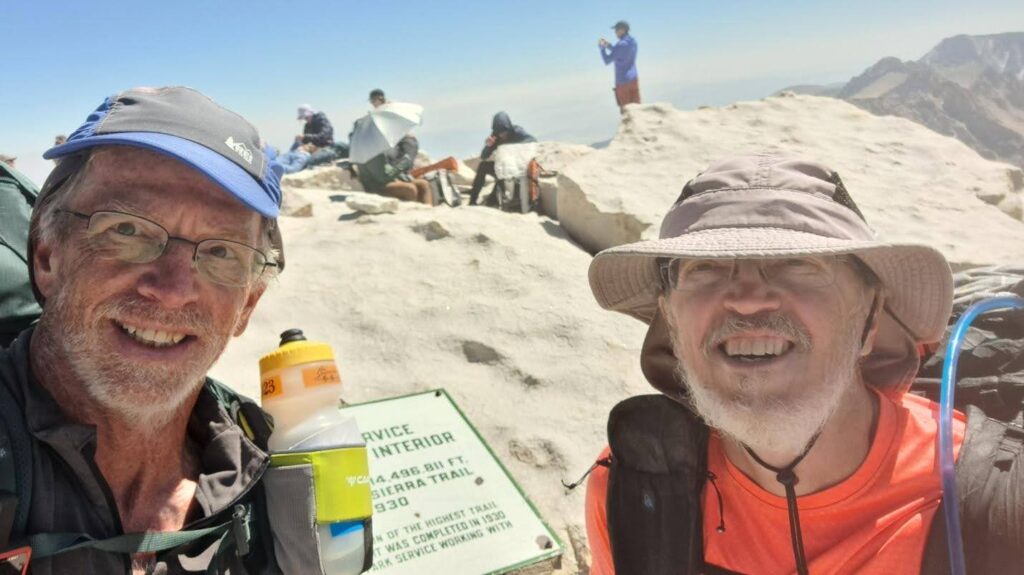 two hikers smiling at the top of Mt Whitney