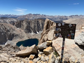 a sign on top of mountains on the JMT