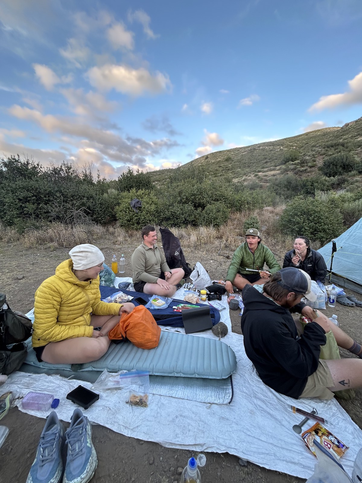 a group of thru-hikers sitting with all their gear out