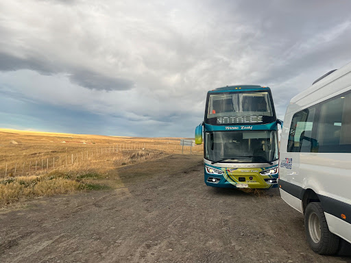 a shuttle bus on a dirt road