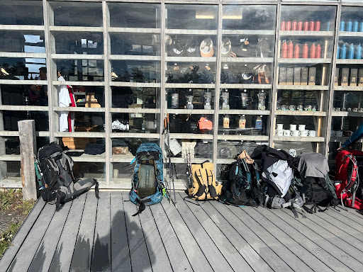 backpacks lining the ground in front of a building