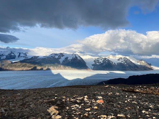 snow covered mountains in the distance with clouds