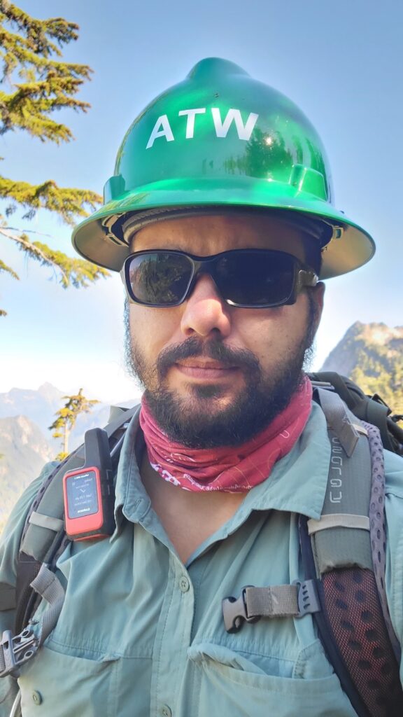 a man with a trail maintenance helmet on